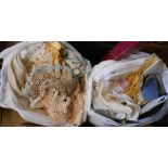 Two bags containing a quantity of textiles including crochet tray cloths, damask and embroidered