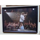 A framed coloured photographic reprint, depicting Brian May on stage at the O2 Arena - circa 2005