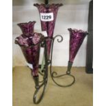 A silver plated epergne stand with four later purple mottled glass flutes