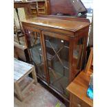 A 93cm 20th Century mahogany display cabinet with glass shelves enclosed by a pair of astragal
