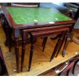 A nest of three reproduction mahogany effect tea tables with green leatherette inset tops