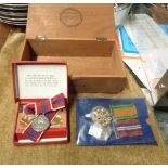 A vintage cigar box containing the 1939-1945 War Medal and WWII Civil Defence Medal (both with