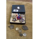 A box containing a quantity of enamelled badges and medals including silver Royal Masonic