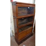 An 86cm Globe Wenicke mahogany four section modular elastic bookcase with cornice and drawer