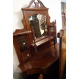 A 1.09m Edwardian walnut display cabinet with multiple bevelled plates, shelves and slender turned