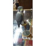 A carved wood and painted figurine of a peregrine falcon on turned wood metal plinth - marked and