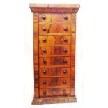 A 46cm early 20th Century rosewood Wellington chest with flight of eight bracket locking drawers and