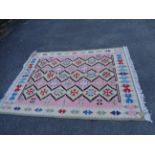 A Chinese handmade kelim with repeat geometric pattern on pink and cream ground