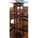 An Edwardian mahogany and strung two tier jardiniere stand, set on slender square supports
