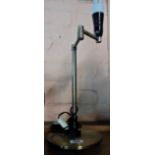 A modern metal adjustable table lamp with brassed finish