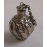 An antique Eastern white metal snuff bottle of spherical form