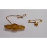 A late Victorian 15ct. gold ornate panel bar brooch - Birmingham 1891, with safety chain - sold with