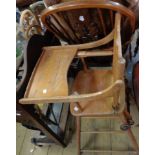 An old beech and elm metamorphic child's highchair with flanking iron wheels to back