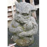 A concrete garden statue depicting a troll