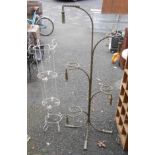 Two vintage wrought iron shop display stands, one of rope twist form with tassel finials and painted