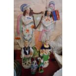 A large Victorian Staffordshire flat back figurine depicting musicians - sold with a pair of