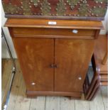 A 52cm 1930's mahogany cabinet with four slide drawers and shelf enclosed by a pair of cupboard