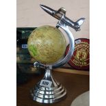 A reproduction Art Deco style globe of the world with aeroplane to top