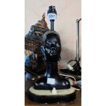 A vintage plaster table lamp in the form of an African female head