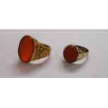 A 9ct. gold ornate ring shank, set with oval carnelian panel - sold with a smaller unmarked similar