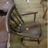 An old child's stick back elbow chair with later finish and moulded solid seat, set on turned