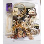 A tin containing a quantity of assorted costume jewellery including a cased set of Lotus simulated
