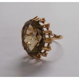 A vintage 9ct. gold dress ring, set with large faceted oval smokey quartz - London 1973