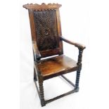 A 17th Century joined oak wainscot armchair chair with later top rail, carved decoration to back