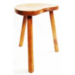 A Robert (Mouseman) Thompson oak stool with shaped seat featuring carved mouse to edge, set on