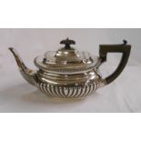 A silver teapot of semi-reeded oval design - London 1906