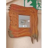 A small decorative carved and stained wood craft mirror by Beachcomber entitled Reflections of Souix