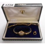 A Tissot box containing a vintage 9ct. gold cased lady's wristwatch on plated expanding strap - sold