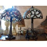 A pair of modern cast brass table lamps of tree form with bronzed effect finish and Tiffany style