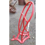 A metal wall hanging saddle stand with red plasticote finish