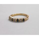 A hallmarked 585 (14ct.) gold ring, set with three small diamonds interspersed with four sapphires -