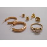 A pair of 9ct. gold hoop earrings, a pair of studs and a small opal panel ring