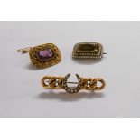 A yellow metal seed pearl set kerb and horseshoe pattern brooch - sold with an amethyst panel brooch