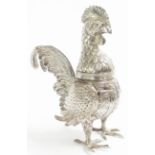 A 16.5cm high continental white metal cockerel pattern pounce pot/caster with articulated wings