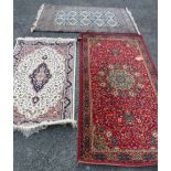 Two small handmade rugs - sold with a machine made worsted rug