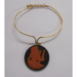 A boxed Wedgwood black basalt and terracotta cameo disc pendant on gold plated wire bracelet