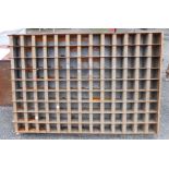 A large vintage industrial metal pigeonhole storage rack
