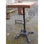 An old cast iron table base with later wooden block top
