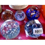 Five glass paperweights including applied bubble and aventurine examples