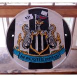 A modern painted cast iron Newcastle United sign