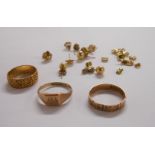 Two hallmarked 9/375 gold wedding bands, another marked Solid 9ct Gold and a small selection of