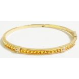 A hallmarked 750 (18ct.) gold clasp bracelet, set with three paved rows of yellow sapphires