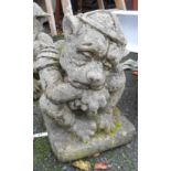 A concrete garden statue depicting a troll