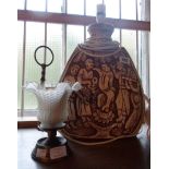 A large vintage plaster table lamp depicting figures making merry - sold with a reproduction