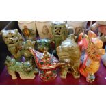 Four 20th Century Chinese pottery dog fo models - sold with a dragon figurine and a metal novelty