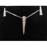 A hallmarked 750 (18ct.) white gold spike shaped pendant, set with eleven graduated channel set